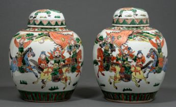 A pair of Chinese famille verte jars and covers, 20th c, enamelled with warriors, 28cm h Hairline