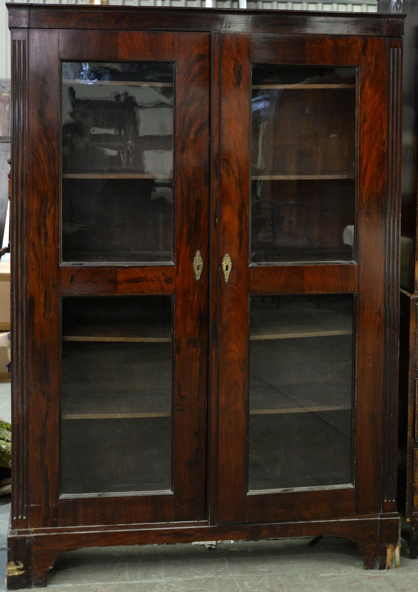 A grained rosewood bookcase, 19th c, fitted with adjustable shelves enclosed by a pair of glazed
