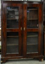 A grained rosewood bookcase, 19th c, fitted with adjustable shelves enclosed by a pair of glazed