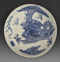 A Chinese blue and white saucer dish, 20th c, painted in underglaze blue with dragons, 28cm diam