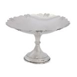 A George V silver cake stand, with ribbon bow border, 19.5cm diam, by Britton, Gould & Co,