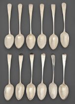 Two sets of uniformly crested George III and Victorian silver dessert spoons, Old English pattern,