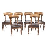 Six Victorian carved walnut dining chairs,  on reeded front legs, the seats with brown nailed