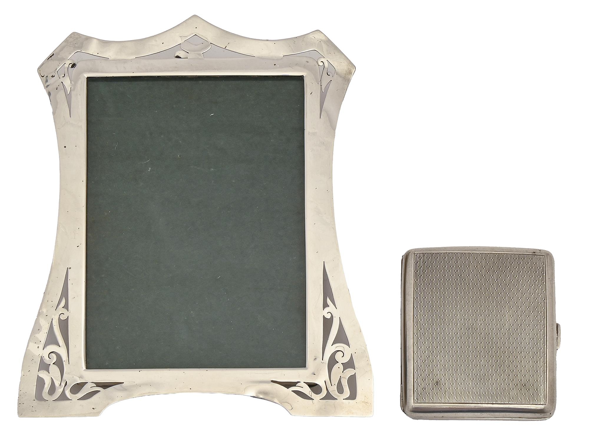 An Edwardian pierced silver photograph frame, 18cm h, by Lawrence Emanuel, Birmingham 1909 and a