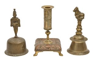 Two English brass hand bells, late 19th c, 18 and 19cm h and a copper and brass candlestick (3)