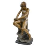 A Goldscheider bronze painted and gilt terracotta figure of an archer boy whittling a stick, 1897-