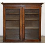 A Victorian rosewood bookcase with glazed doors, originally on cupboard base