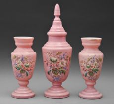 A Victorian pink glass garniture, painted with flowers, vase and cover 42cm h (4)