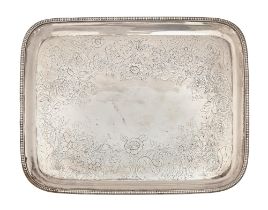 A Sheffield Plate oblong salver, early 19th c, the field flat chased with floral border, on bun