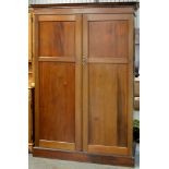 A mahogany wardrobe, c1920, with fitted interior, enclosed by a pair of panelled doors, 192cm h;