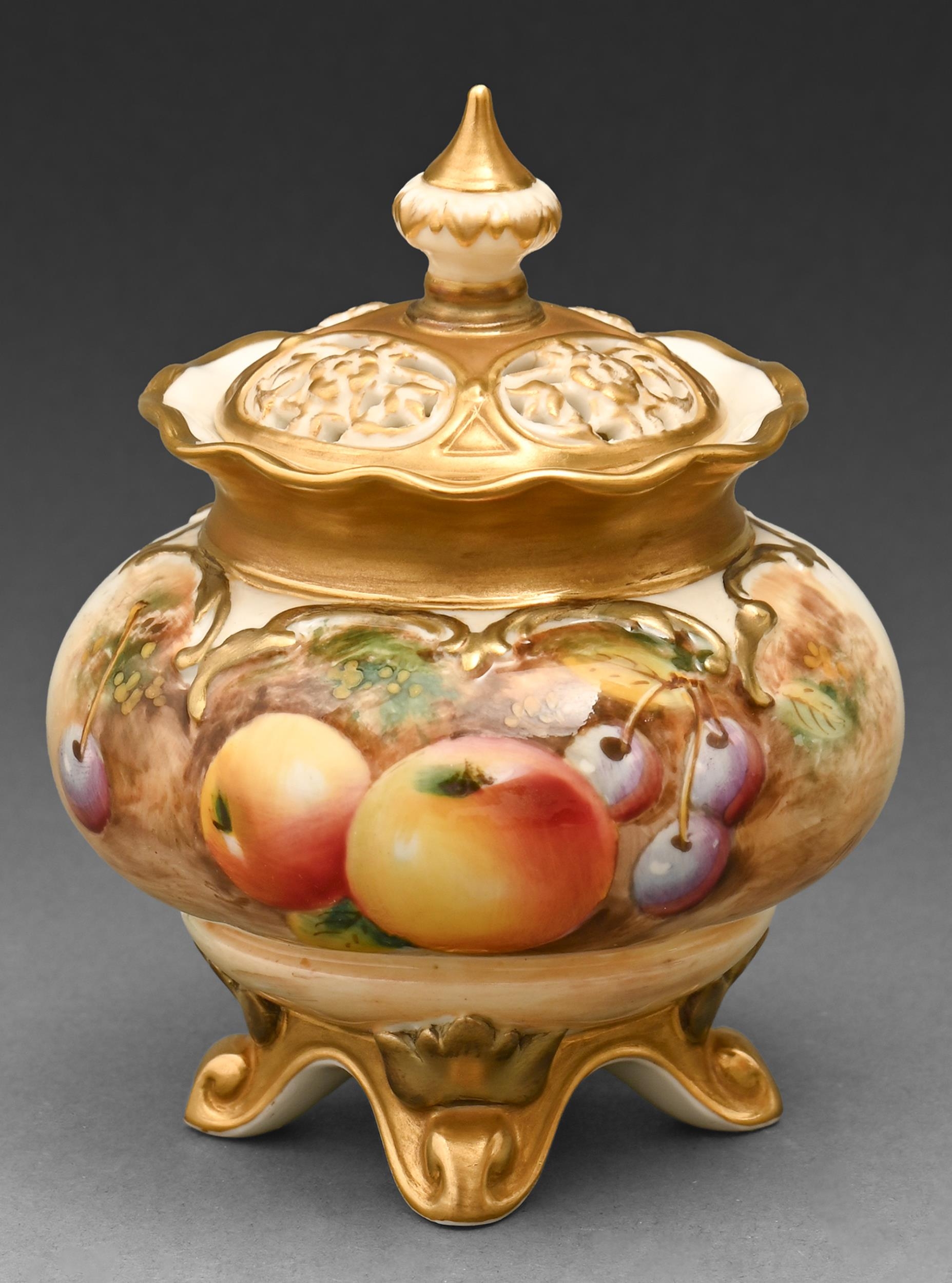 A Royal Worcester pot pourri vase and cover, c1970, painted with fruit, signed, 11cm h, black