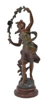 A French fin de siecle spelter sculpture of a windswept young woman with a flowering bough, on