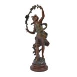 A French fin de siecle spelter sculpture of a windswept young woman with a flowering bough, on