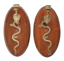 A pair of Indian brass cobra wall sconces, mounted on contemporary oval walnut back plates, 38cm h.