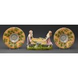 A Czechoslovakian majolica group of a boy and girl with a basket, early 20th c, 25.5cm h and a