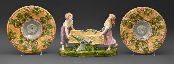 A Czechoslovakian majolica group of a boy and girl with a basket, early 20th c, 25.5cm h and a