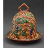 A  reproduction majolica bee skep cheese dish and cover, 35cm h
