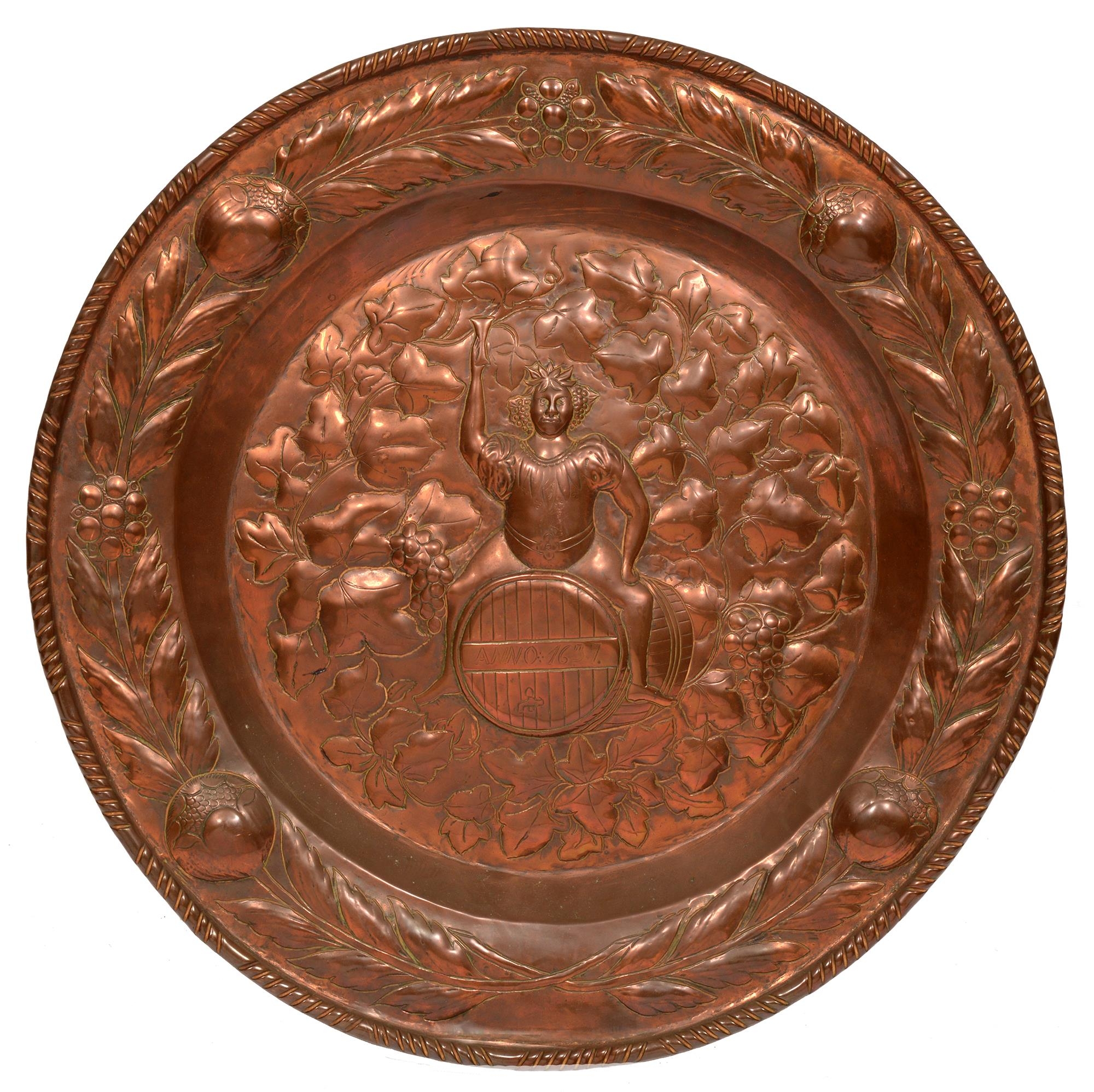 A copper plaque, early 20th c, 46cm diam