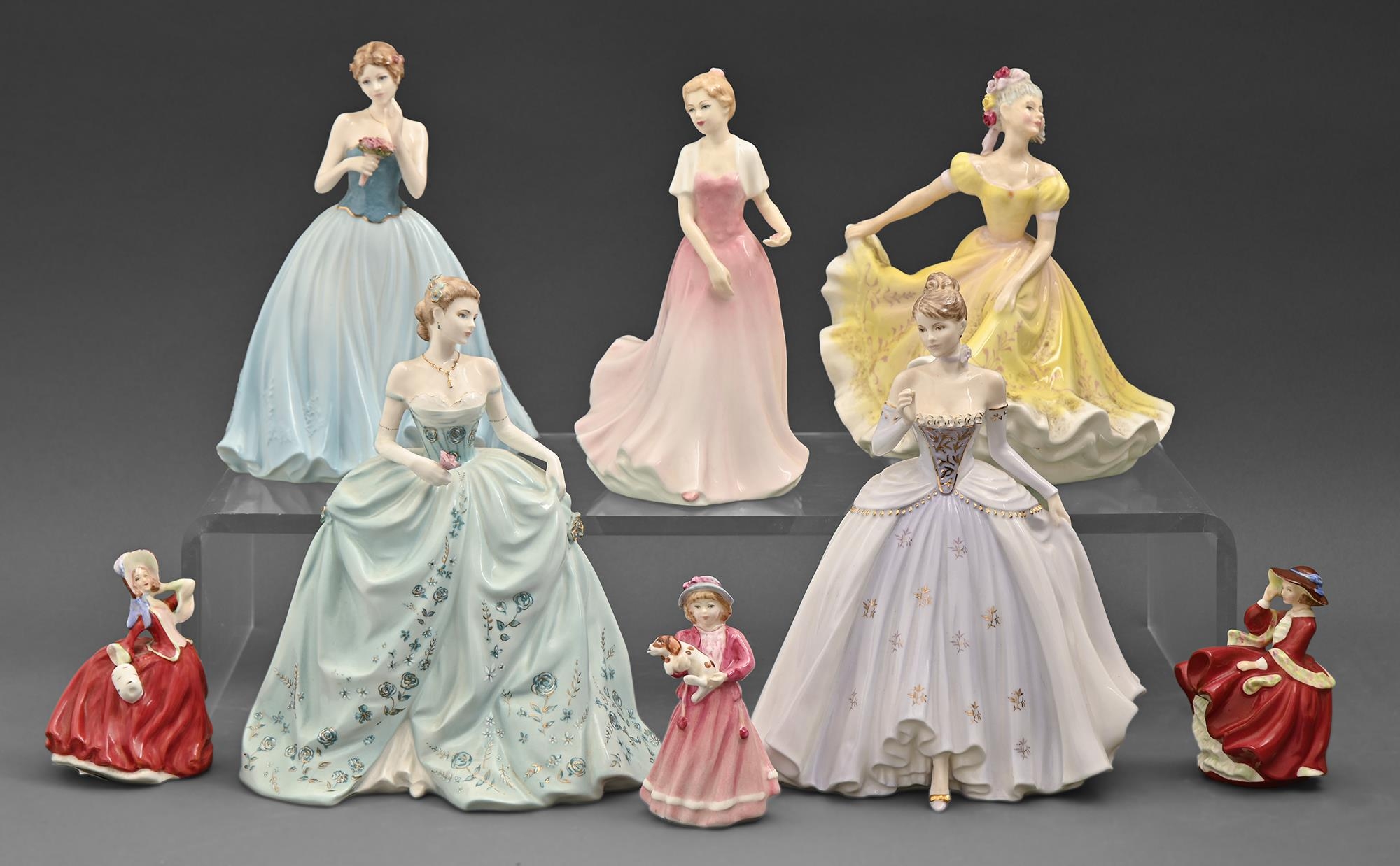 A Royal Doulton porcelain figure of Julie, three miniature Doulton figurines and four Coalport
