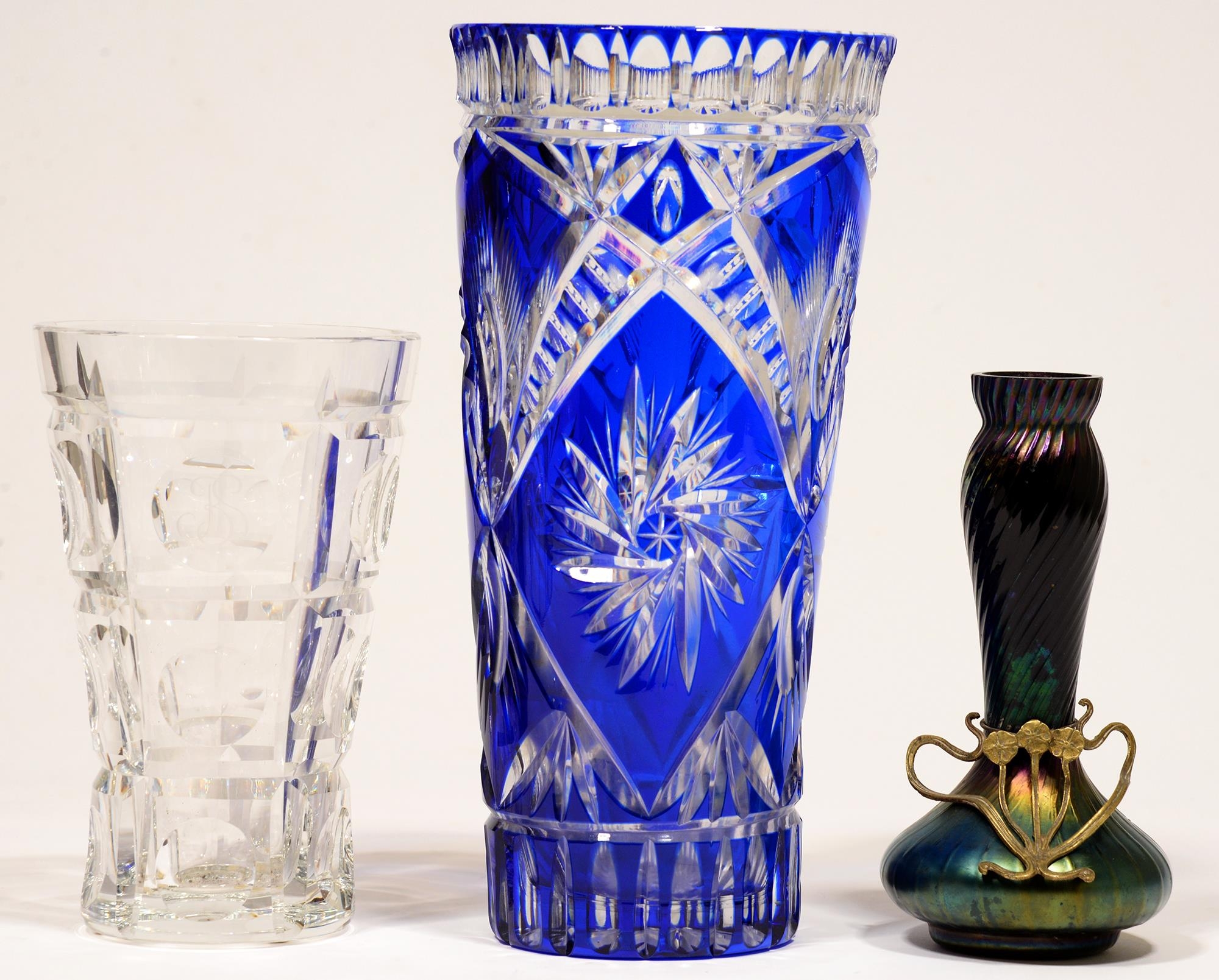 A blue cased and cut glass vase, 30cm h, another, plain glass and a Bohemian iridescent glass