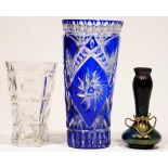 A blue cased and cut glass vase, 30cm h, another, plain glass and a Bohemian iridescent glass