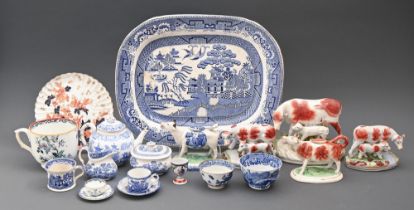 Three Staffordshire cow and calf groups, two cow creamers and blue and white ceramics, including