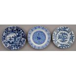 Three Chinese blue and white plates, Kangxi period, painted with a lady and jumping boy or other