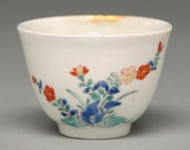 A Kakiemon cup, Edo period, c1700, with rounded sides and slightly everted lip, enamelled with two