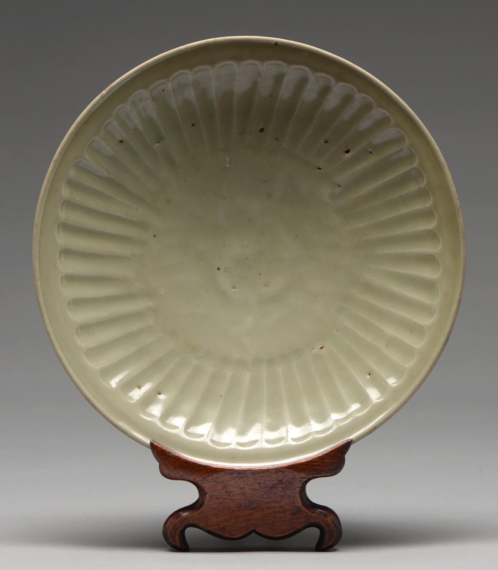 A Swatow Ware dish, Ming dynasty, of fluted form, unglazed inside the foot ring, 28cm diam