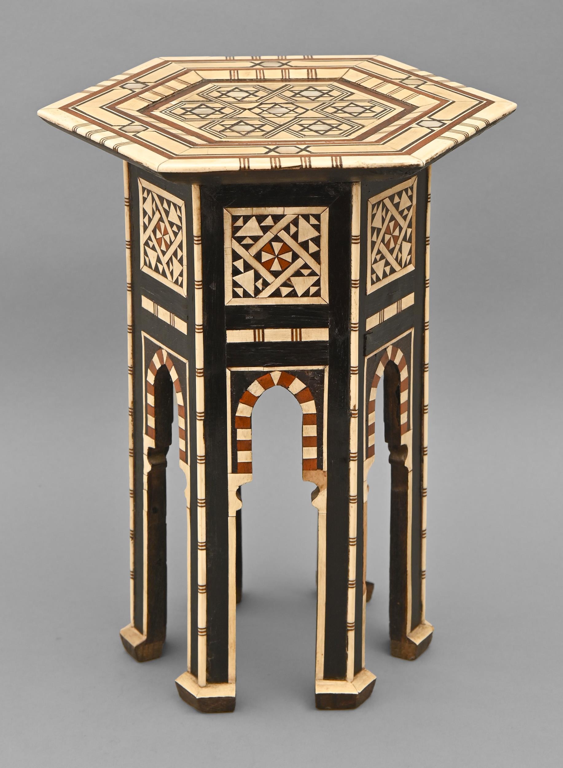 A Middle Eastern mother of pearl and bone-inlaid and ebonised miniature hexagonal table, late 19th
