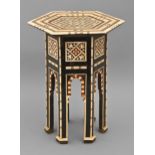 A Middle Eastern mother of pearl and bone-inlaid and ebonised miniature hexagonal table, late 19th