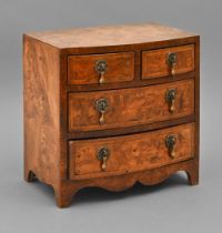 Miniature furniture. A walnut, burr walnut and feather banded chest of drawers, early 20th c, with