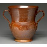 A Derbyshire saltglazed brown stoneware loving cup, Chesterfield, dated 1797, the flared neck