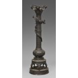 A Japanese bronze candle stand, Meiji period, a dragon entwined around the pillar, the bulbous