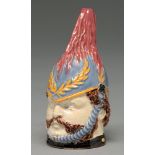 An enamelled creamware candle snuffer in the form of the head of a soldier, 19th c, 95mm h