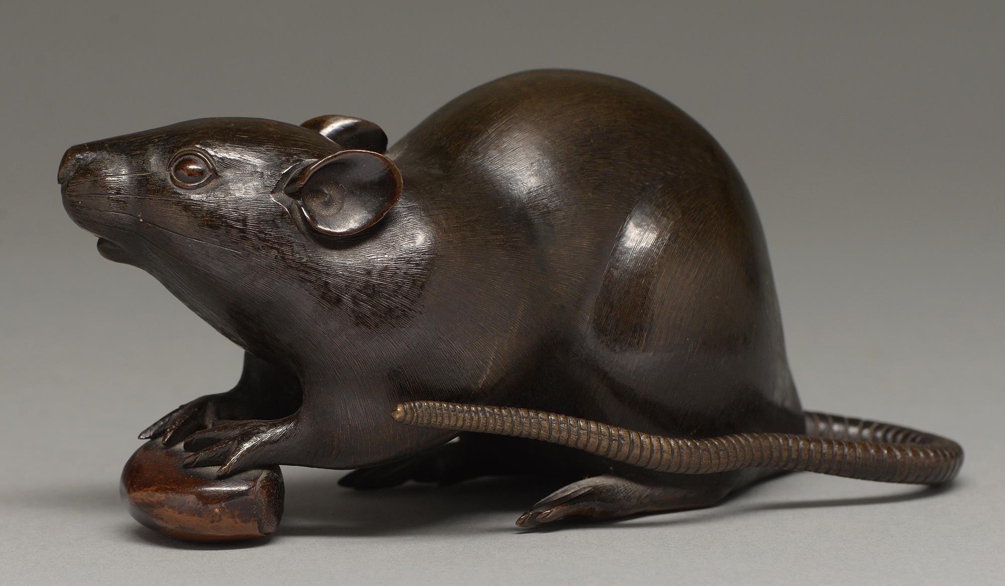 A Japanese bronze okimono of a rat, Meiji period, with finely chiselled fur, the rodent's fore