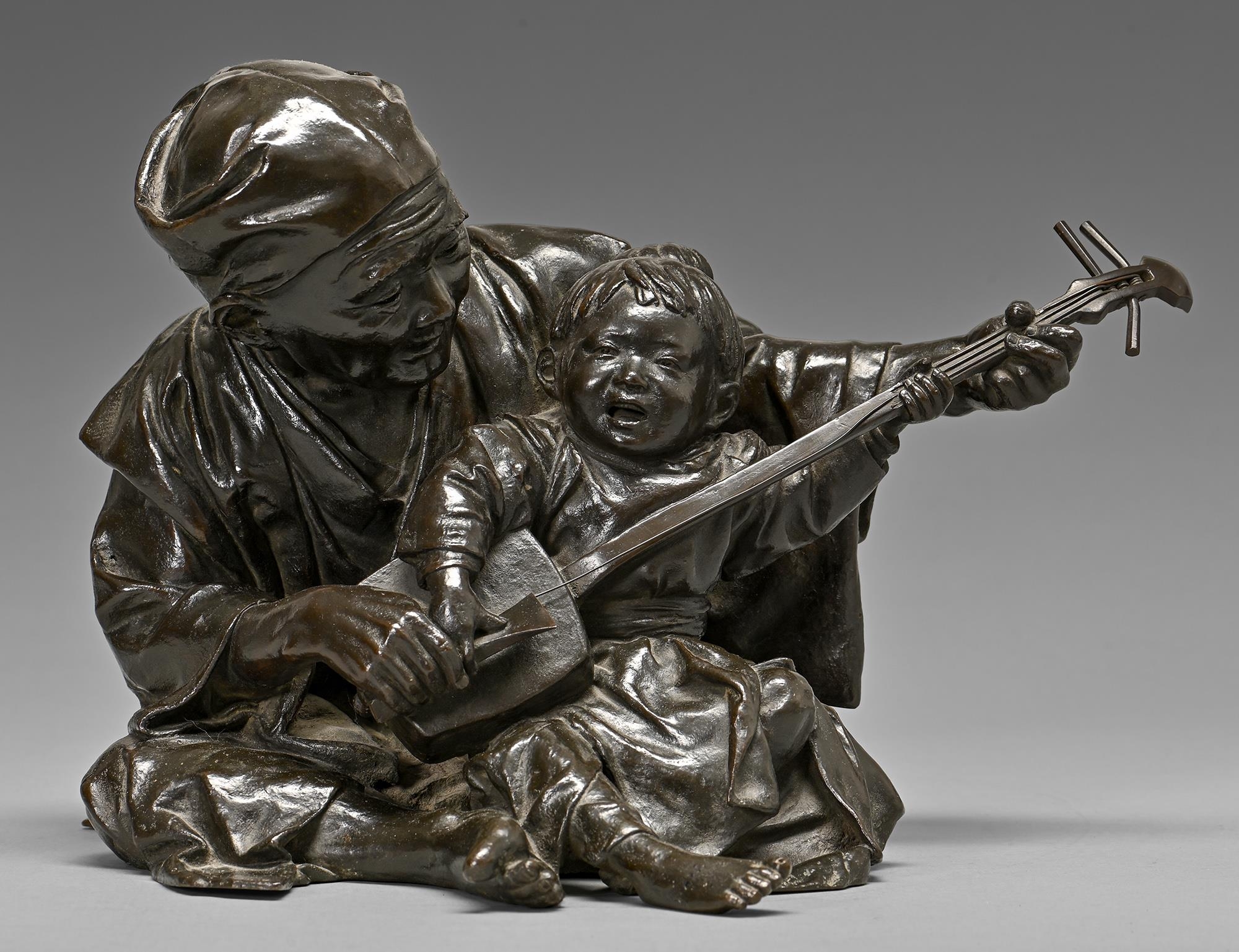 A Japanese bronze sculpture of a father teaching his son to play the shamisen, Meiji period, rich