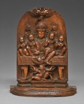 An Indian sandalwood carving of Shiva Parivar, 19th c, 21.5cm h The back slightly warped with one or