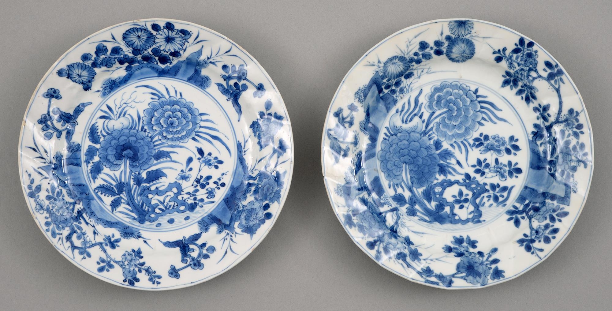 A pair of Chinese blue and white plates, Kangxi period, painted with peonies and other plants, the
