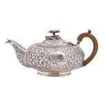 A George IV silver teapot, chased with a Chinese fisherman framed by C-scrolls and flowers on a