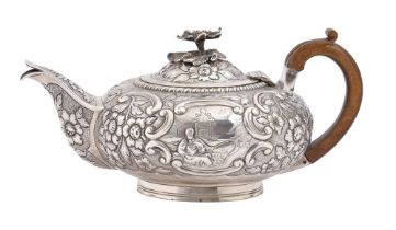 A George IV silver teapot, chased with a Chinese fisherman framed by C-scrolls and flowers on a