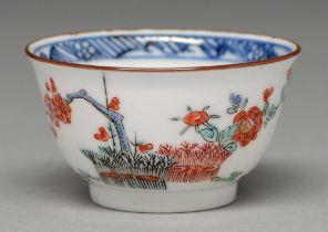 A Kakiemon cup, Edo period, early 18th c, enamelled with banded hedge and blossoming prunus and