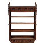 A Victorian reformed gothic oak hanging bookcase, the frieze carved with initials W M A C, the