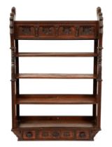 A Victorian reformed gothic oak hanging bookcase, the frieze carved with initials W M A C, the