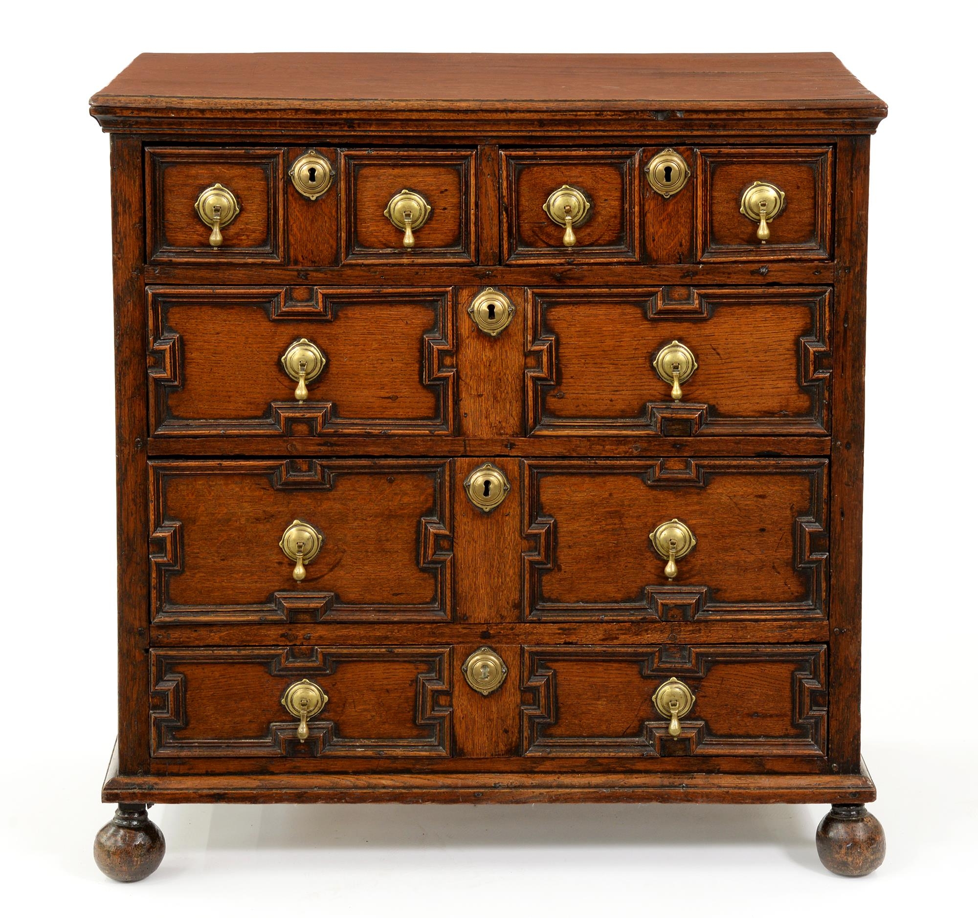 A William III oak chest of drawers, early 18th c, with two short and two long geometrically