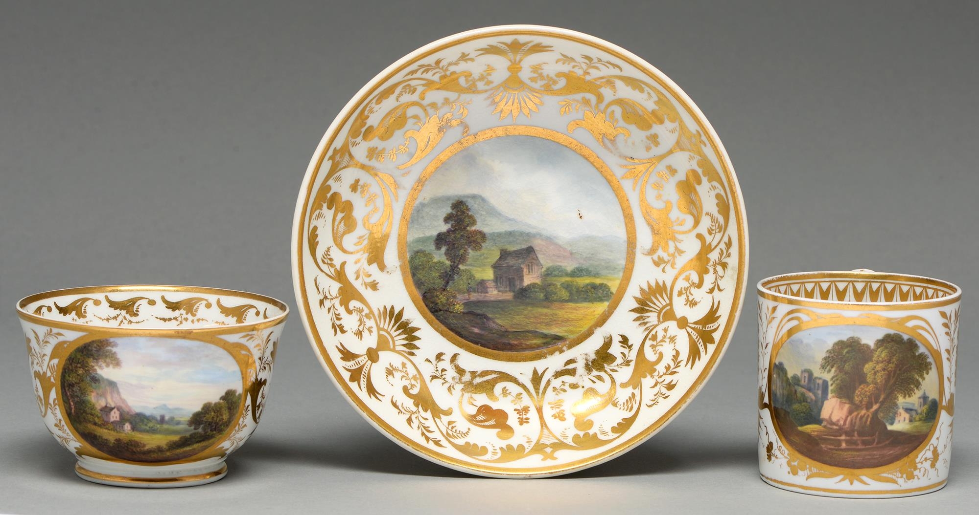 A Derby coffee can, teacup and saucer, c1820, painted by Daniel Lucas or another, with a landscape