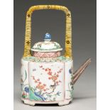 A Chinese famille verte wine pot and cover, Kangxi period, enamelled and gilt with panels of
