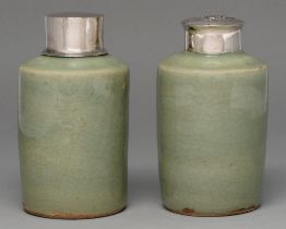 Two Chinese celadon tea caddies, 19th c, the neck unglazed, associated silver coloured metal covers,