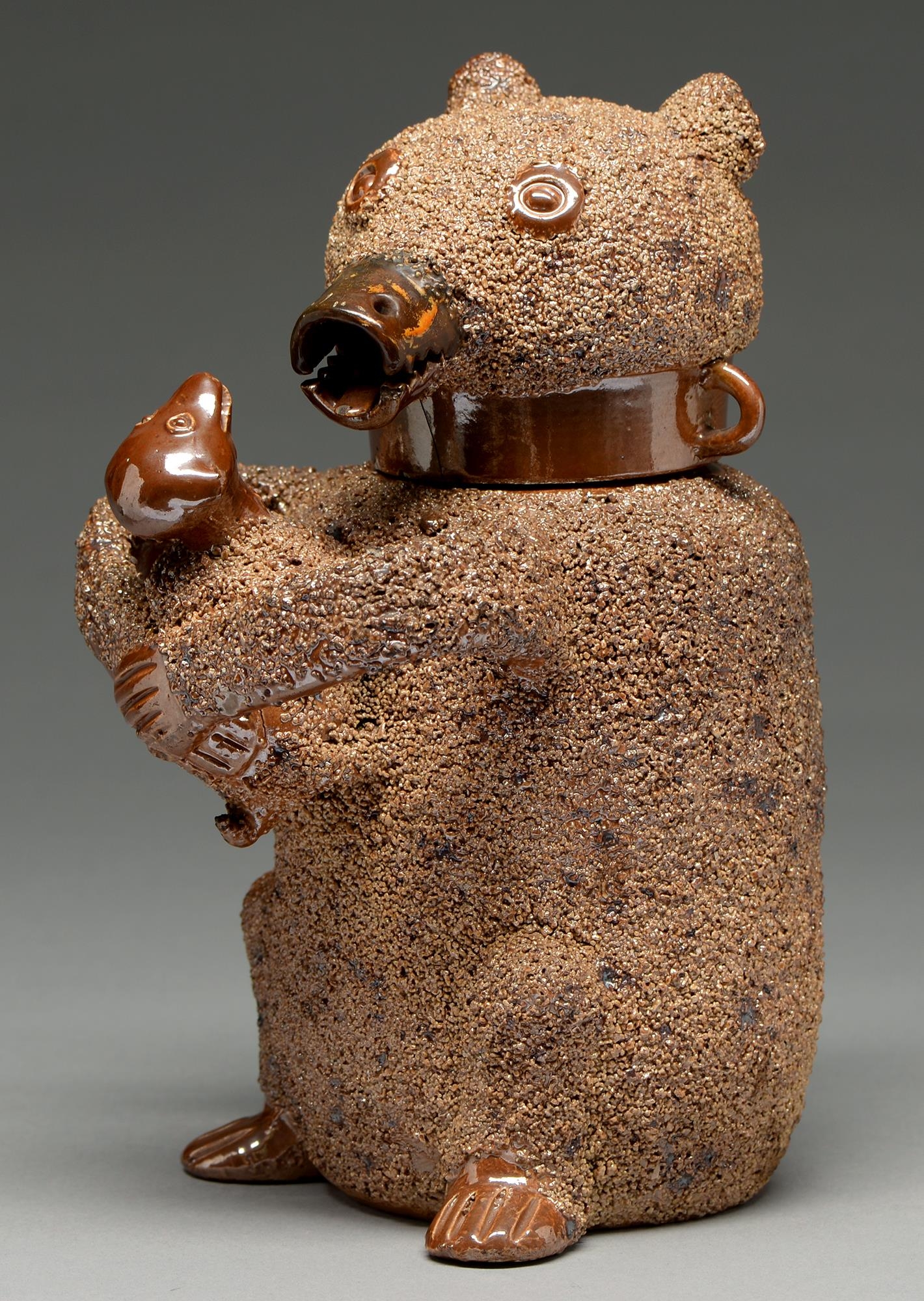 A Nottingham saltglazed brown stoneware bear jug, third quarter 18th c, the bear and the dog