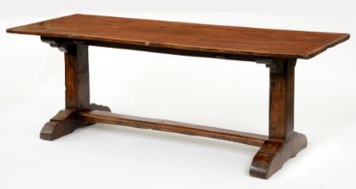 An oak table, the boarded top with cleated ends, on rectangular end supports  with sledge base and